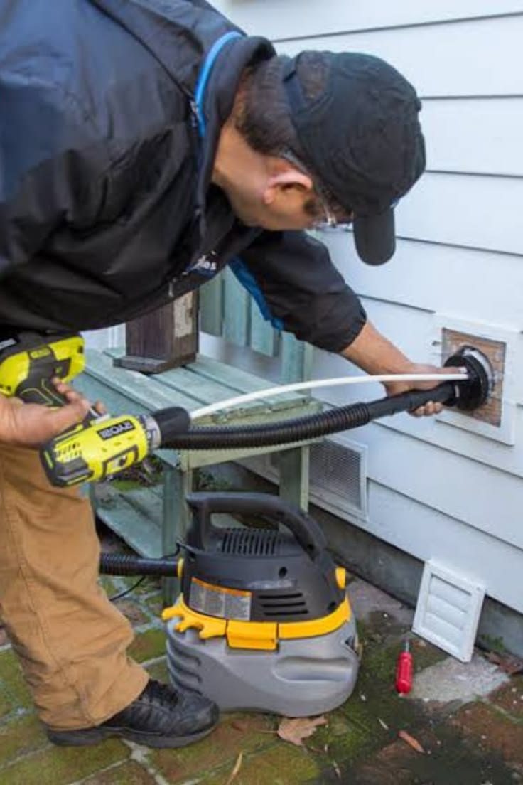 Technician cleaning an exterior dryer vent in Clovis, CA 93611